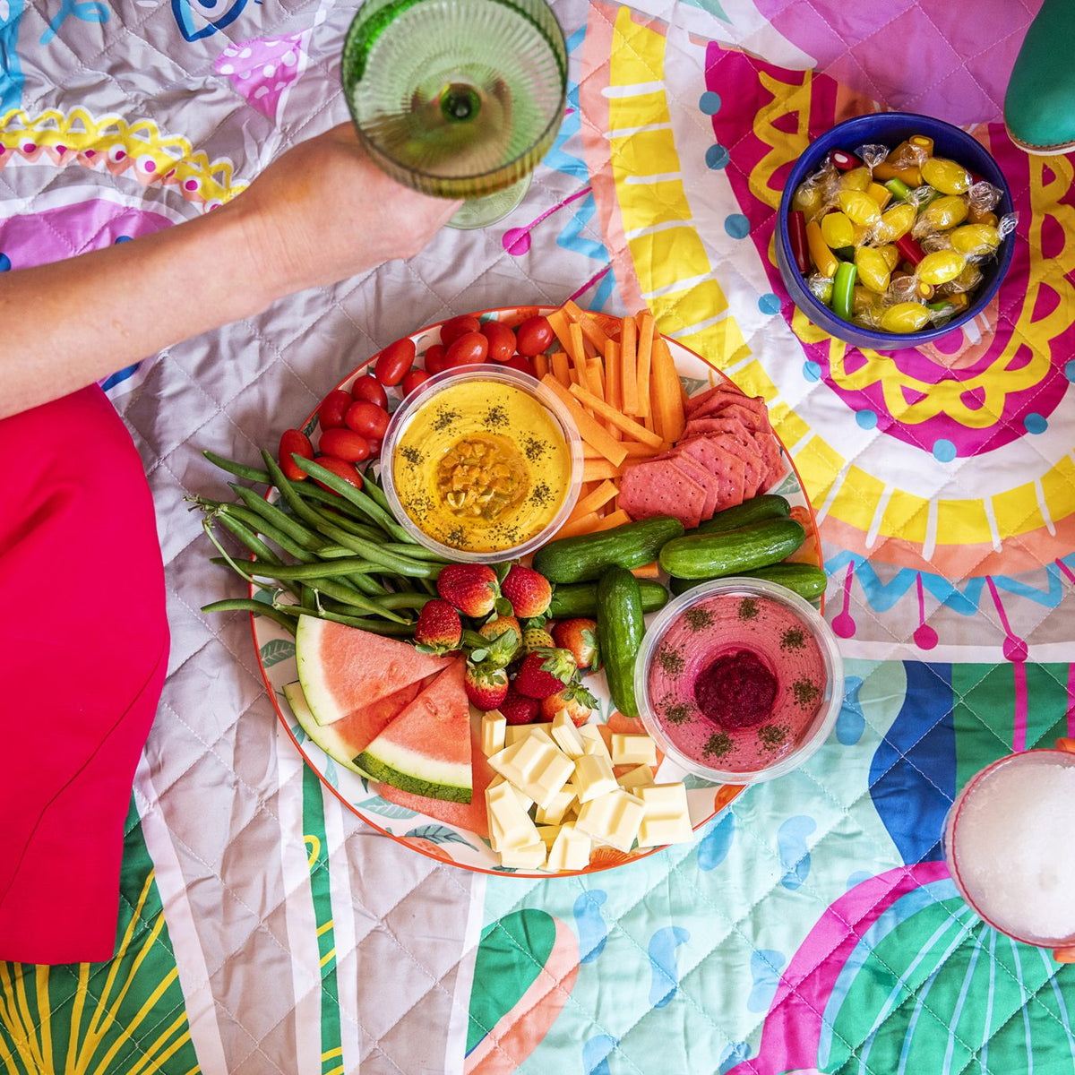 overhead view of friends sharing a grazing platter on the hola mamacita waterproof picnic blanket