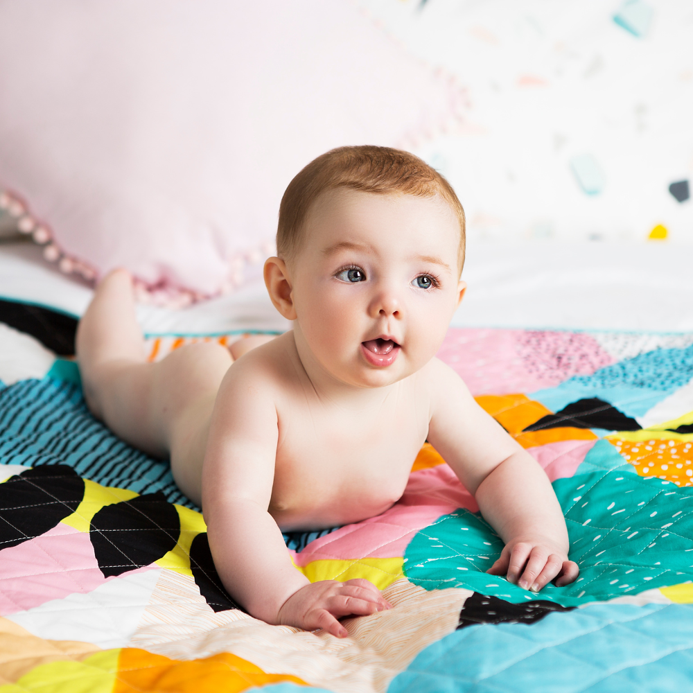 baby nappy free time play mat colourful on bed