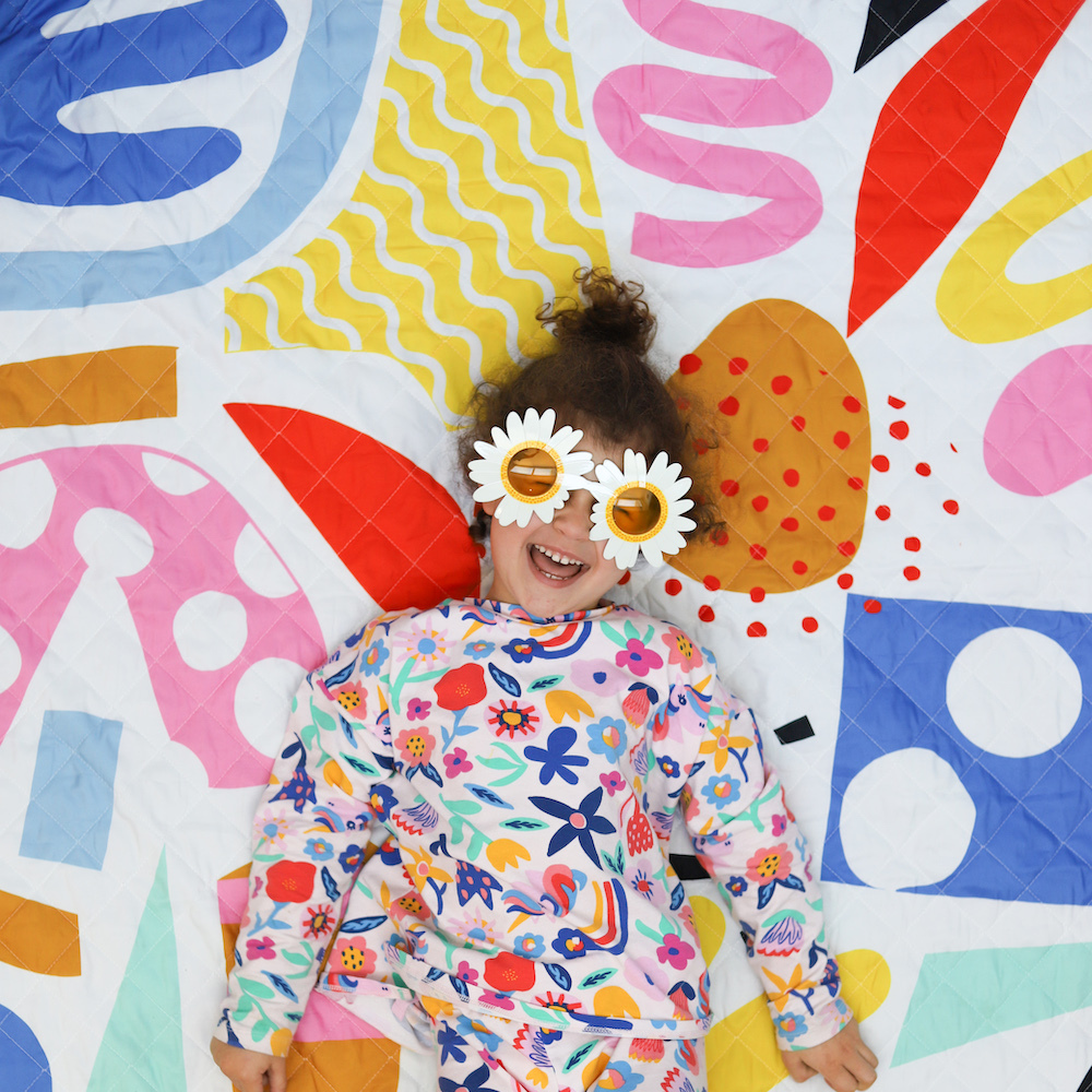 girl smiling on her picnic blanket