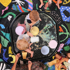 kids playing on black messy play mat