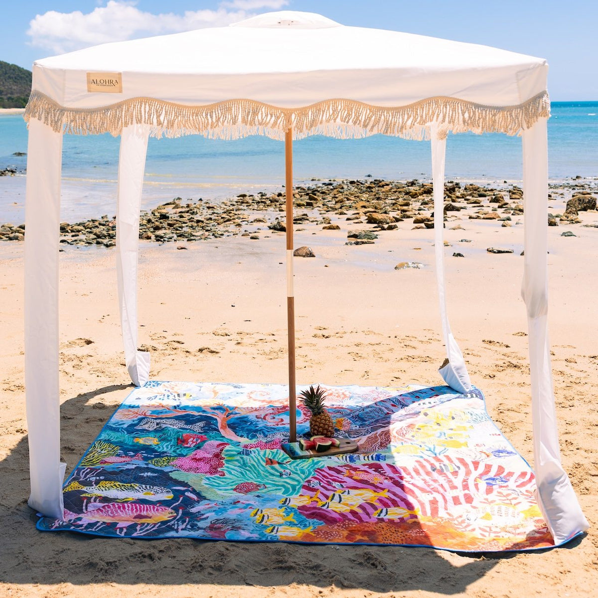 octopus's garden picnic blanket with umbrella hole under a fringed beach cabana