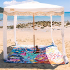 octopus's garden picnic blanket with umbrella hole under a fringed beach cabana
