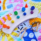close-up of wooden toys on the quilted pop pip pow large waterproof playmat