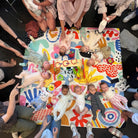 overhead view of a mothers group with babies lying on the pop pip pow waterproof picnic blanket