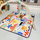 pop pip pow regular waterproof playmat under a wooden baby play gym in a nursery