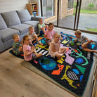 group of children having a snack on the rock candy waterproof picnic blanket indoors