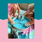 Messy foam play in the Tray Play on a Rudie Nudie waterproof playmat